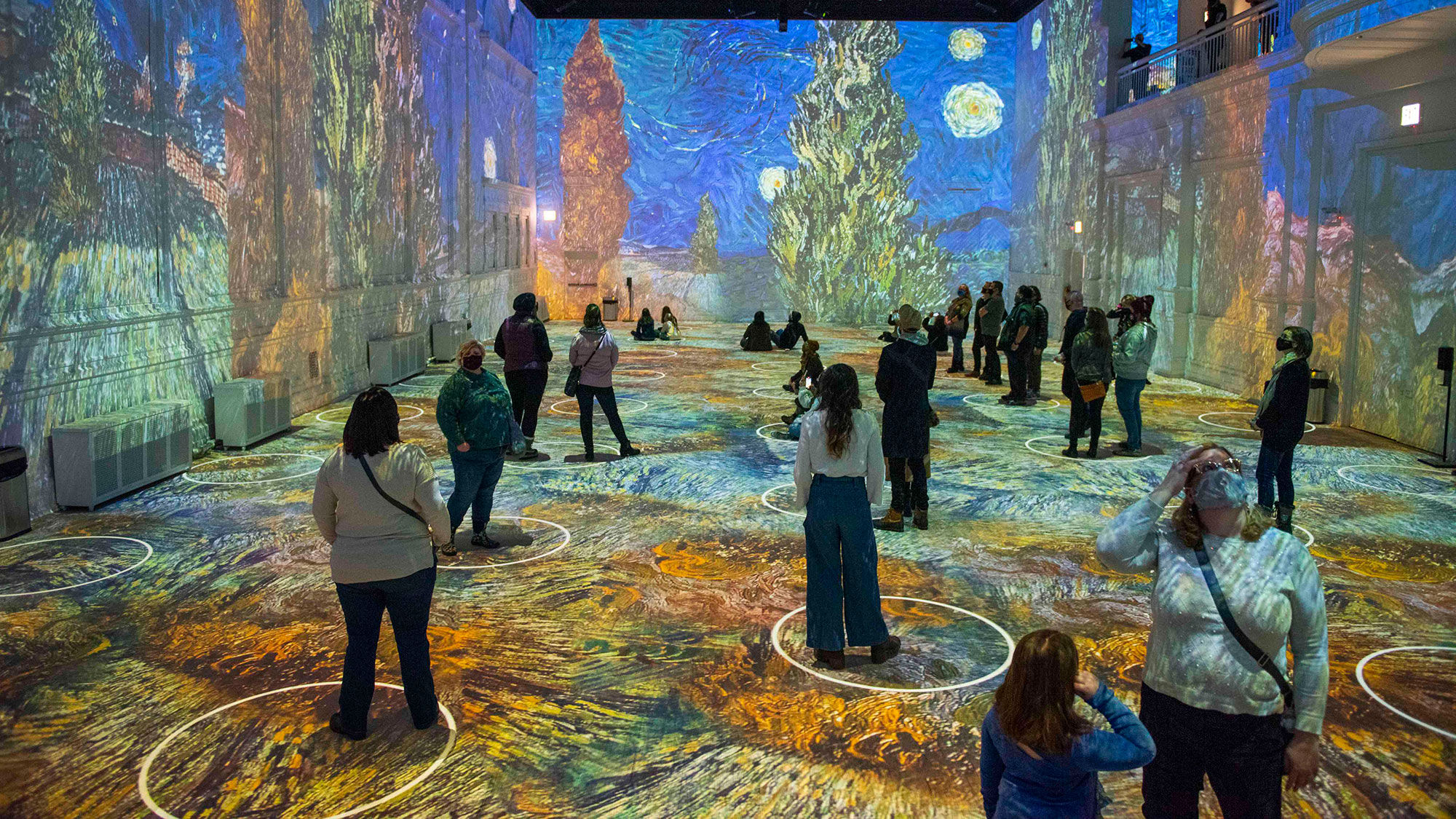 Digitally projected social distancing circles on gallery floors will ensure appropriate spacing at "Immersive Van Gogh."