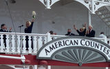 Angie Hack prepares to christen the American Countess with a bottle of Maker's Mark in New Orleans. To the right is CEO John Waggoner and his wife, Claudette; they are Hack's parents.