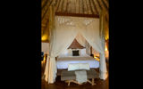 Hand-carved canopy beds are the center piece of the round villas at Origins Luxury Lodge Costa Rica.