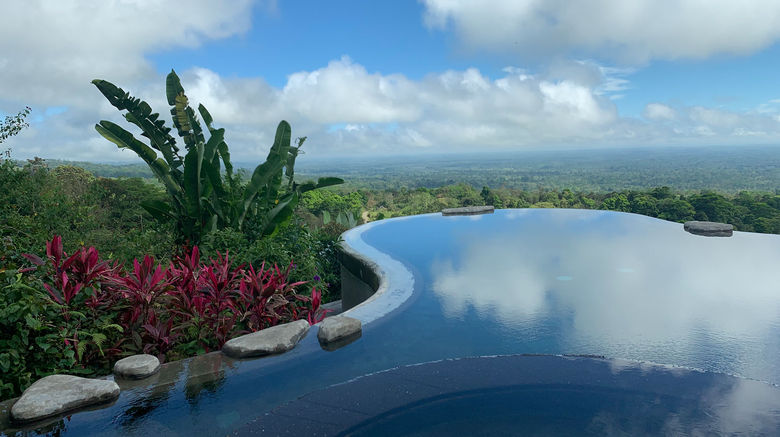 Origins Luxury Lodge Costa Rica features and infinity pool with sweeping views of the valley and, on a clear day, Lake Nicaragua.