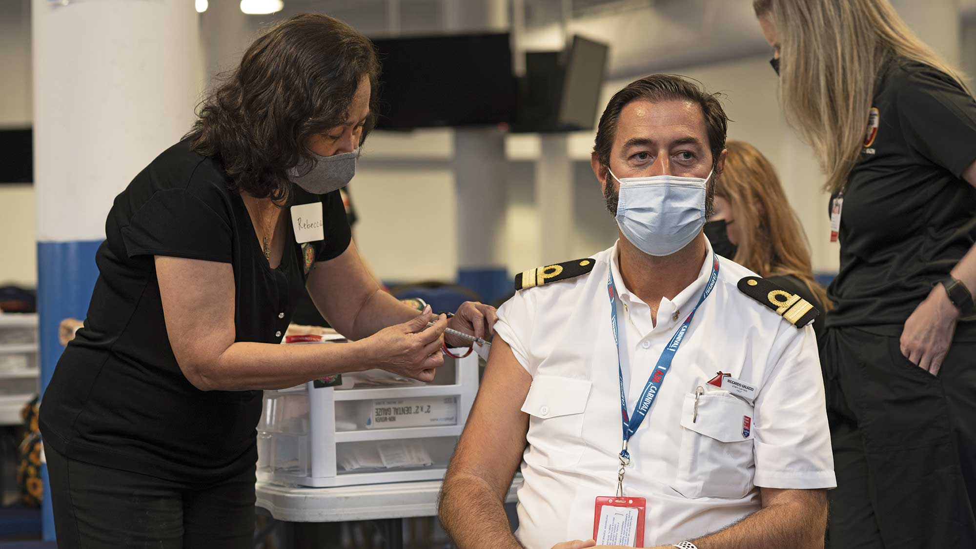 Carnival Cruise Line staff captain Riccardo Galazzo was vaccinated during a rally in Galveston, Texas. Ships where nearly all passengers and crew are vaccinated can drop mask and distancing rules, the CDC says.