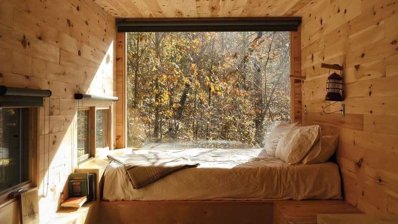 Each Getaway cabin features a queen bed and large windows.
