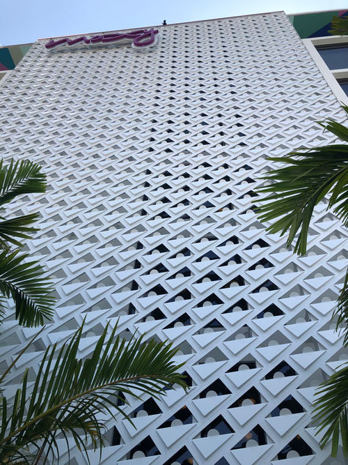 An eight-story brise-soleil screen, perforated in a contemporary triangular pattern and topped with the Moxy logo, is the dominant exterior feature of the hotel. An eight-story brise-soleil screen, perforated in a contemporary triangular pattern and topped with the Moxy logo, is the dominant exterior feature of the hotel.