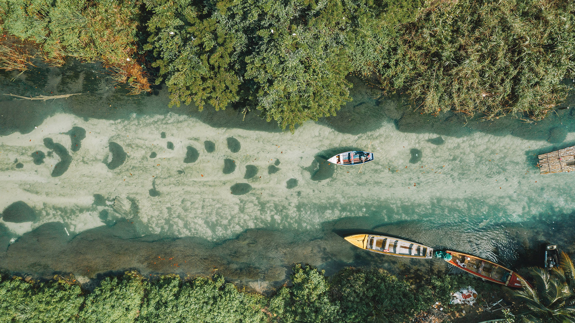 Boating on the Martha Brae River in Jamaica, a popular Montego Bay excursion.