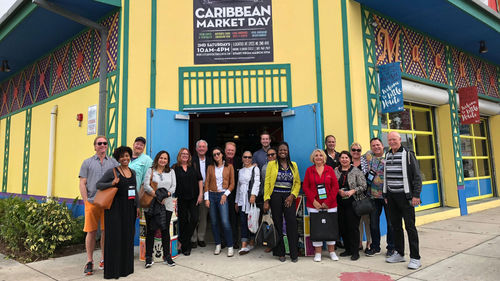 A group of Black Cultural Heritage Tour participants at the Caribbean Marketplace in the Little Haiti neighborhood of Miami.