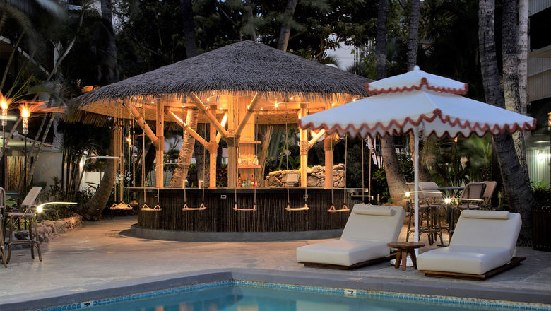 The Green Lady, new poolside bar at the White Sands Hotel, features swinging seats that hang from the bar's roof.