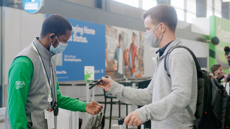 A SeaTac airport employee verifies that the reservation of SEA Spot Saver virtual queuing customer.