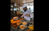 A cook serves a smoked pork sandwich at the new Star Grill.