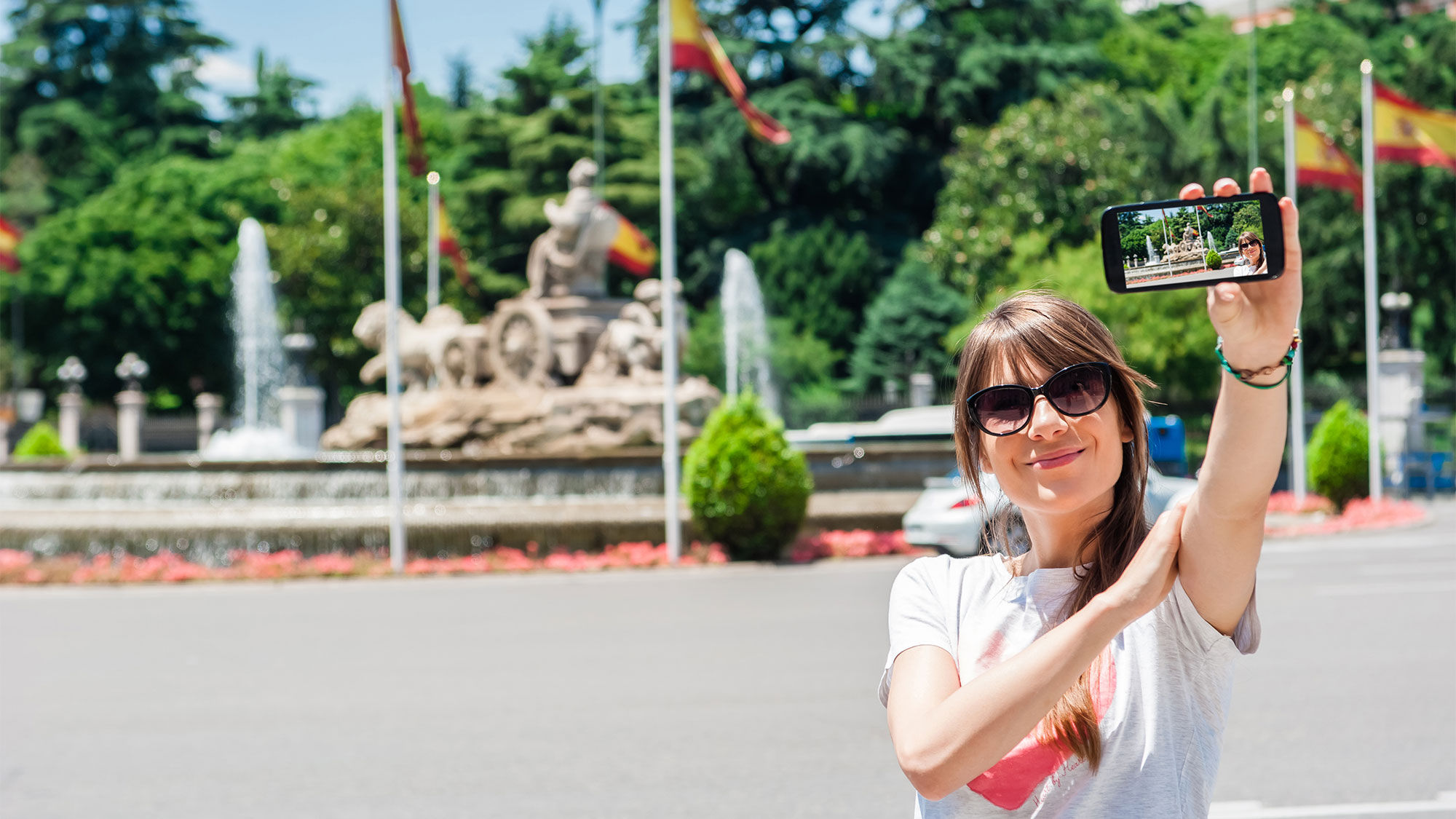 A tourist at the Cibeles Fountain in Madrid.