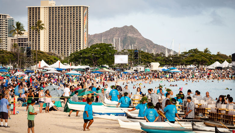 A lantern-floating ceremony draws a crowd at Ala Moana Beach Park in Honolulu.