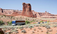 A motorcoach tour rolls through Arches National Park in Utah.