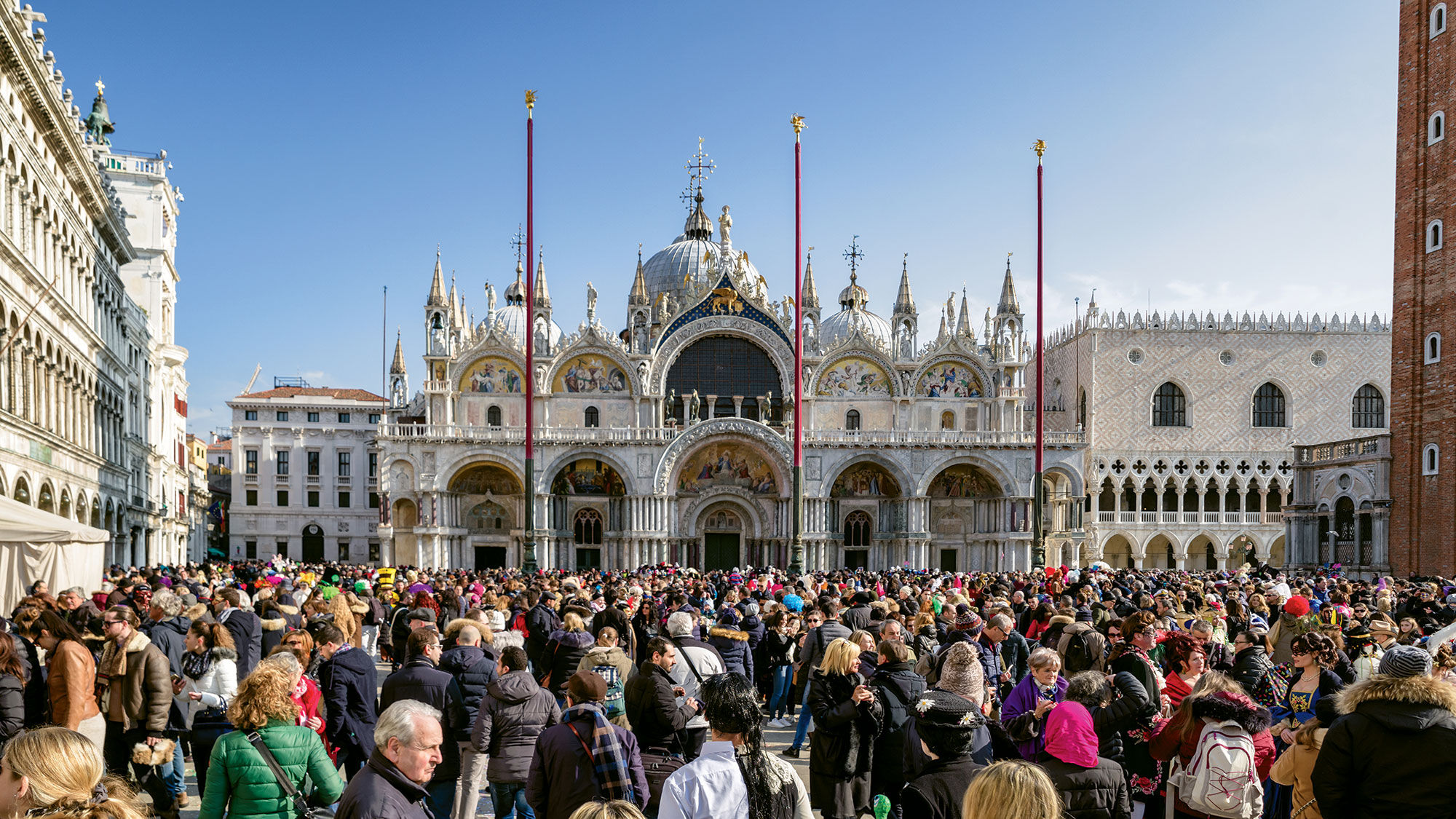 Throngs of people fill St. Mark's Square in Venice during Carnival last February.