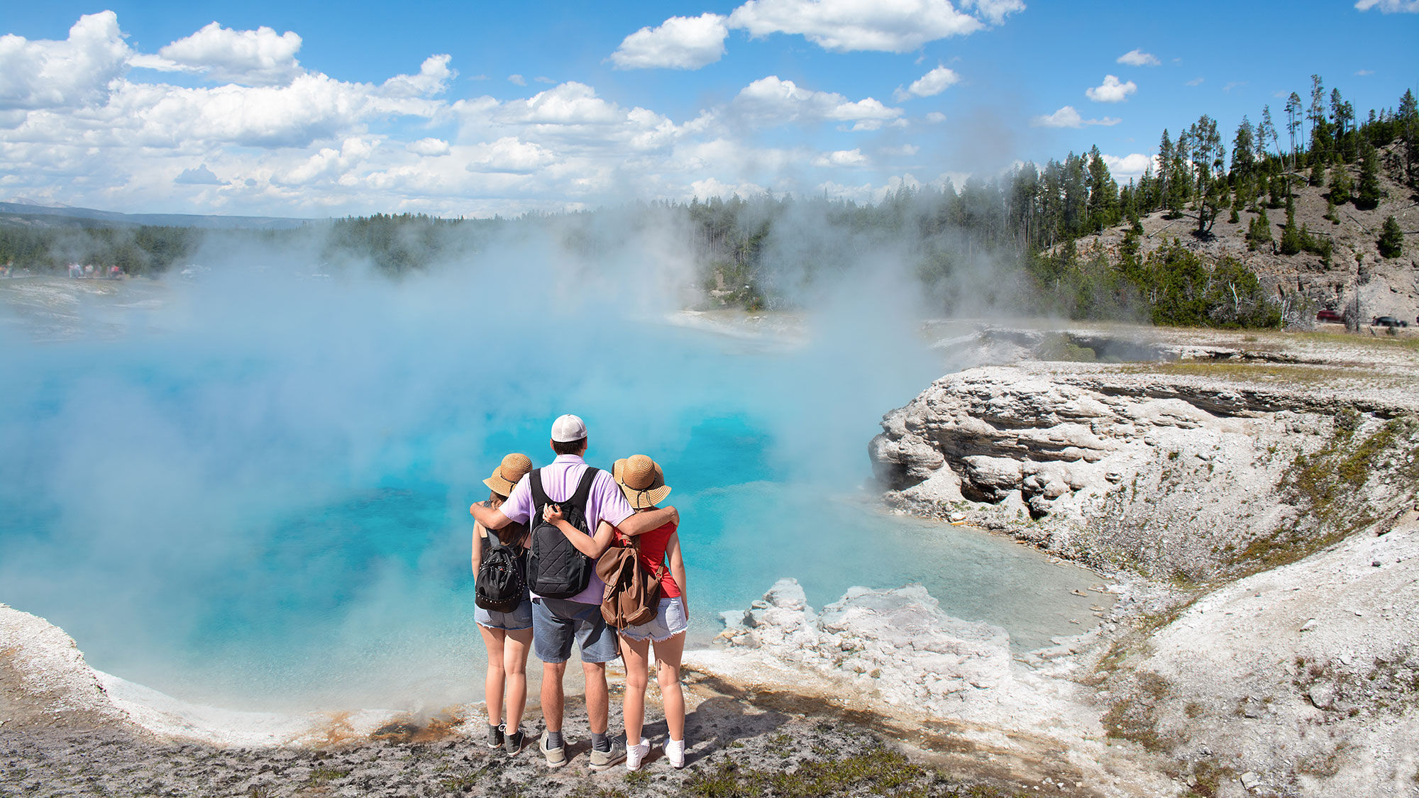 A family at the Midway Geyser Basin in Yellowstone National Park.