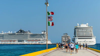 Cruise ships and passengers in Costa Maya, Mexico. A new report from Phocuswire says that 2023 will be a significant year for the industry's recovery, with full recovery predicted for 2024.