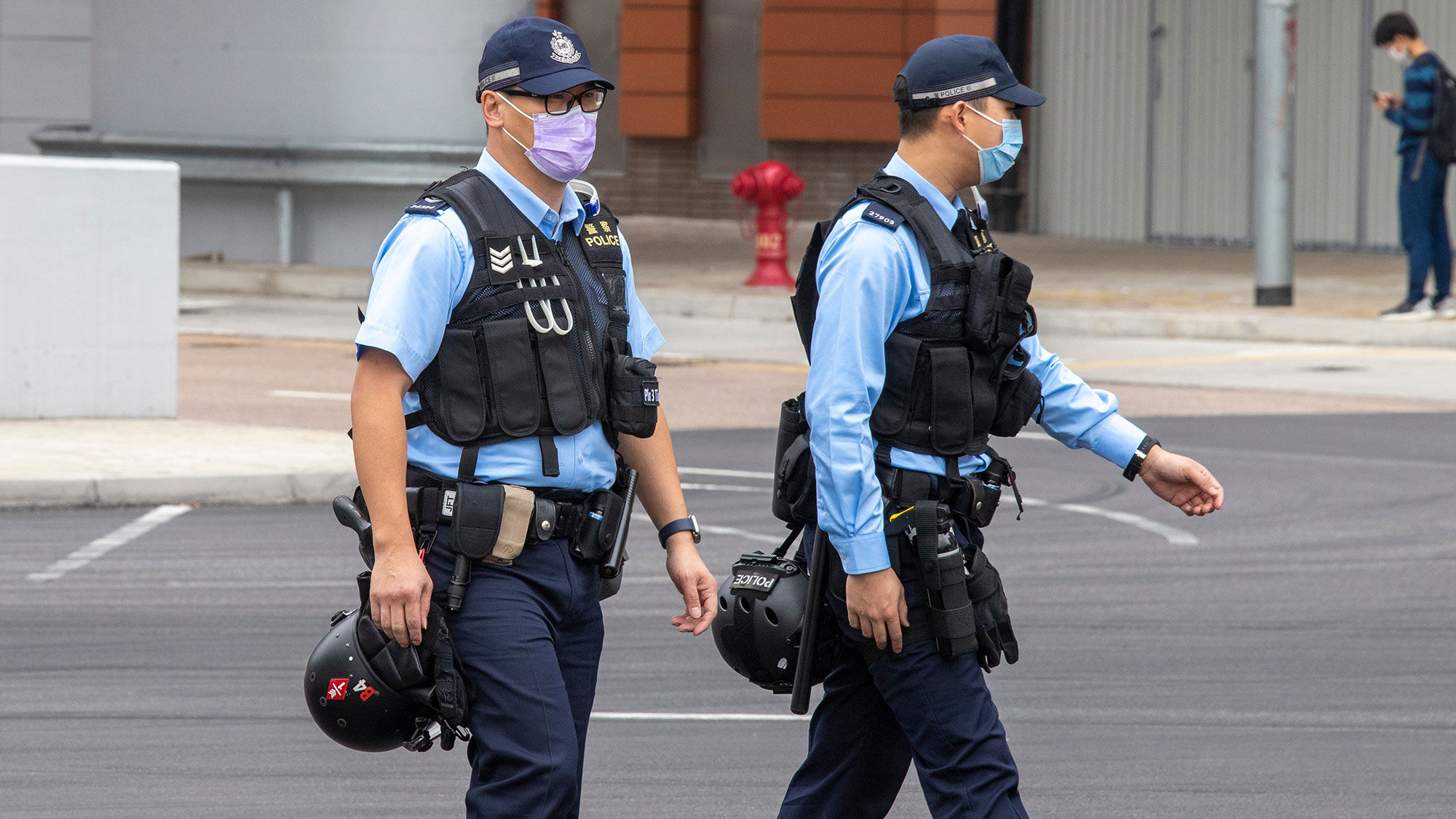 Hong Kong police wearing medical masks while patrolling outside the West Kowloon rail station.