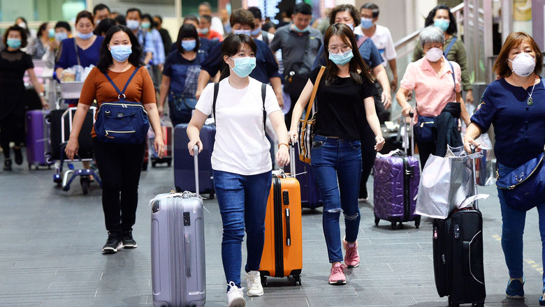 Airline passengers wearing medical masks at Kuala Lumpur International Airport in early February.
