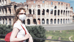 Colosseum in Rome, masked woman [Credit: Viacheslav Lopatin/Shutterstock.com]
