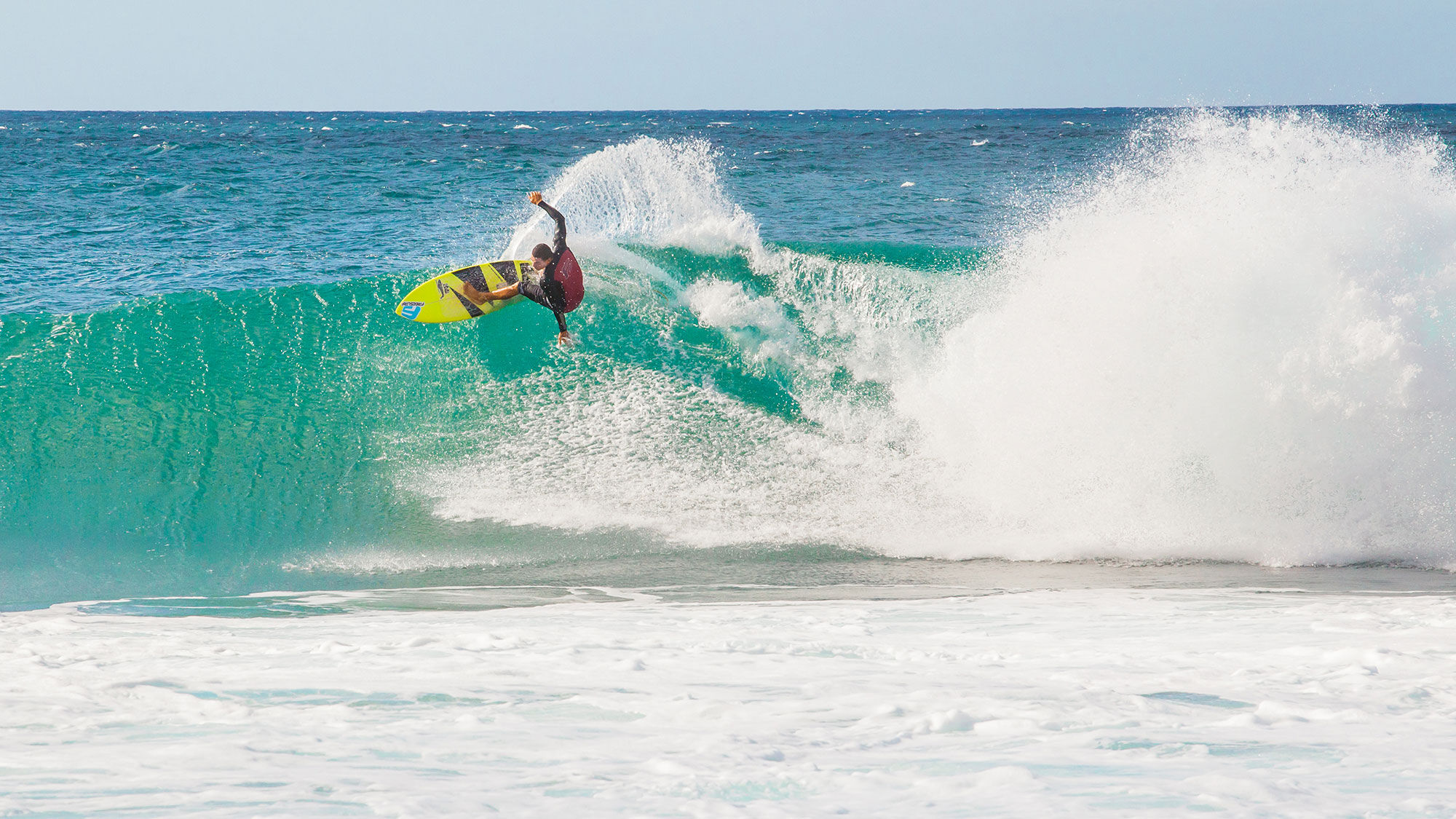 A surfer on Oahu's North Shore. The island is currently in Tier 4 of a five-tier reopening plan.