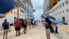 A group on a Celebrity Cruises' tour gathers on the dock in Cozumel outside the Celebrity Edge. Passengers on the Adventure of the Seas, docked across the quay, were allowed to roam freely in port.
