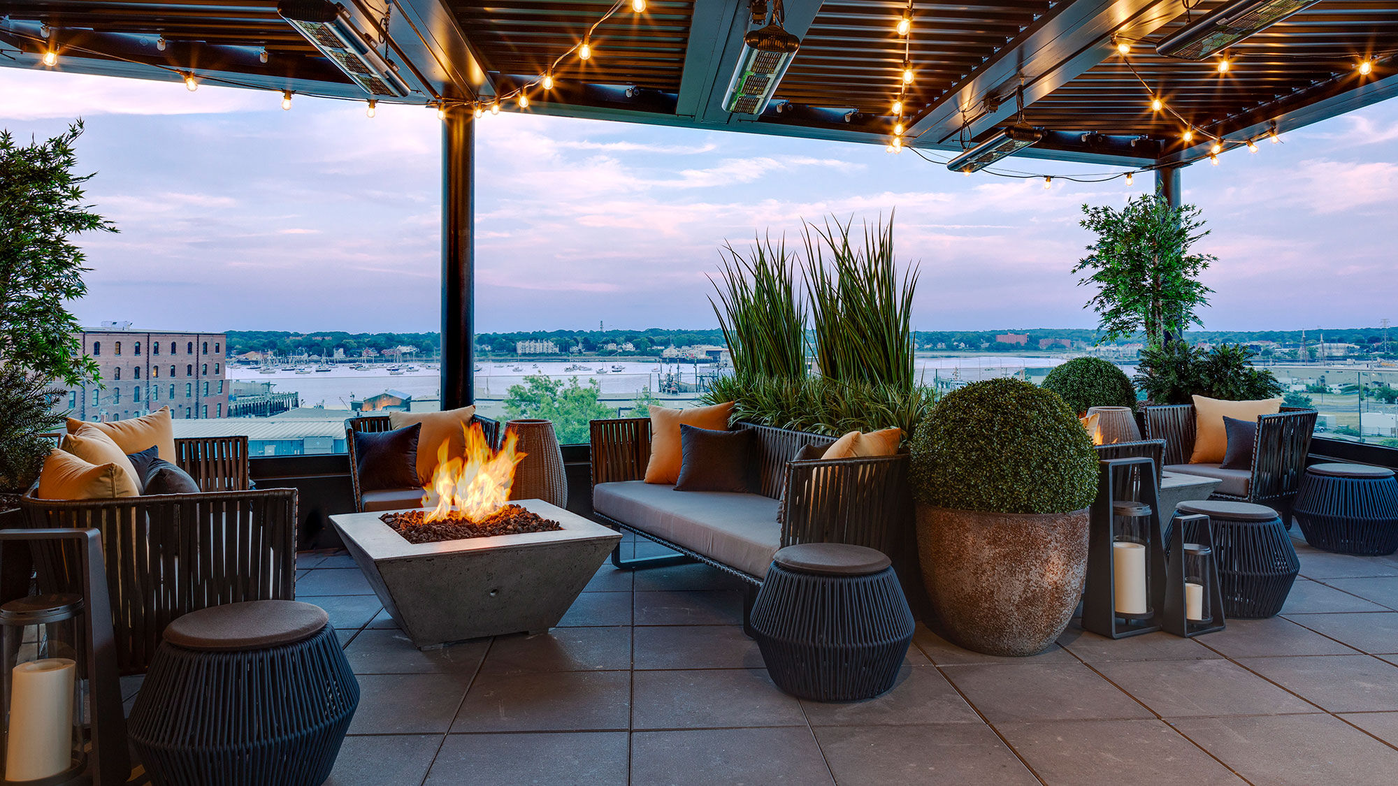 The outdoor terrace of Luna at the Canopy by Hilton Portland overlooks Commercial Street and the city's harbor.