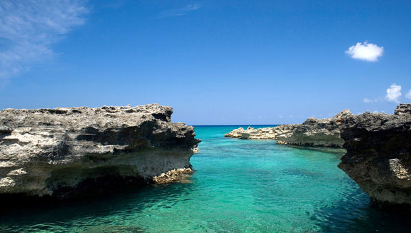 Smith Cove on Grand Cayman. The Cayman Islands, which will reopen on Nov. 20, is now requiring lateral flow testing for all vaccinated international travelers. Smith Cove on Grand Cayman. The Cayman Islands, which will reopen on Nov. 20, is now requiring lateral flow testing for all vaccinated international travelers.