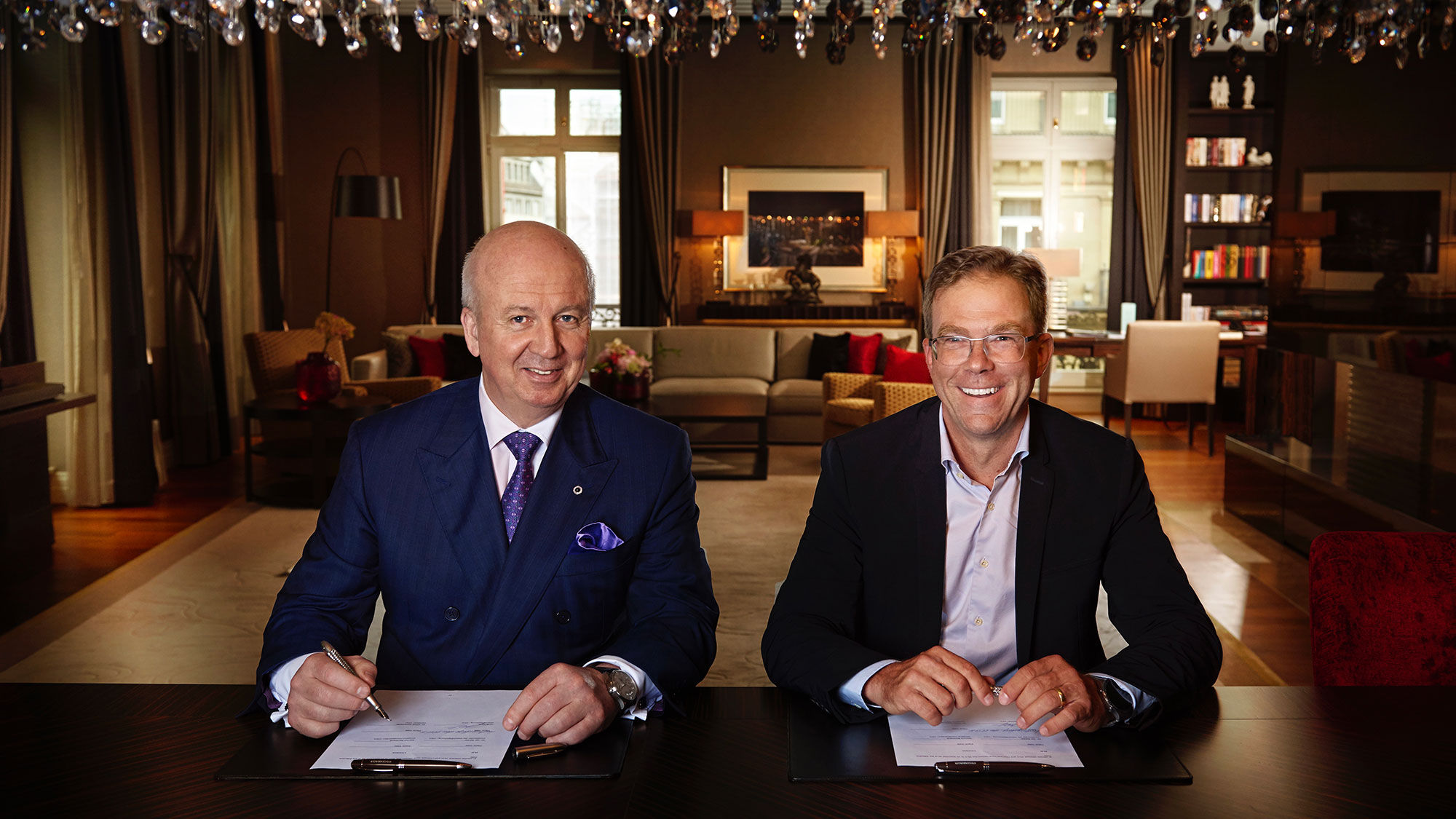 Steigenberger Hotels CEO Marcus Bernhardt (left) and Porsche Design CEO Jan Becker signing an agreement to create a joint hotel brand.