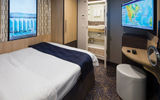 An inside solo cabin on a Royal Caribbean International ship with a virtual window with live images of the sea and ports.