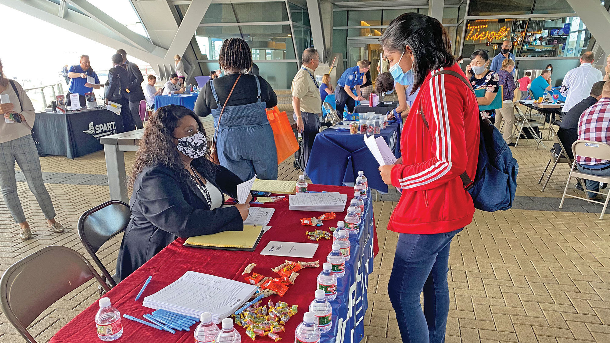 Prospect Airport Services had a table at a recent job fair in Denver. The company has raised wages to attract applicants.