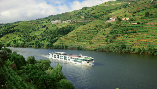 The Scenic Azure sailing through Peso da Regua on the Douro River in Portugal.