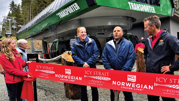NCL president Harry Sommer, Huna Totem Corp. CEO Russell Dick and Icy Strait Point vice president of operations Tyler Hickman prepare to cut a ribbon to inaugurate a gondola transport system connecting one side of Icy Strait Point to the other.