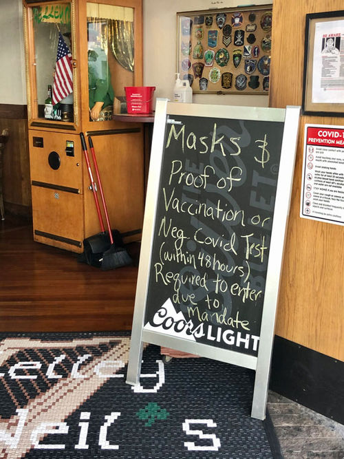A sign board outside Kelley O'Neil's, a pub on Lewers Street in Waikiki, alerts patrons to new rules on Oahu.