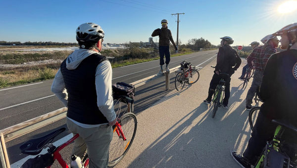 The bike-tour guide stops to explain our surroundings.