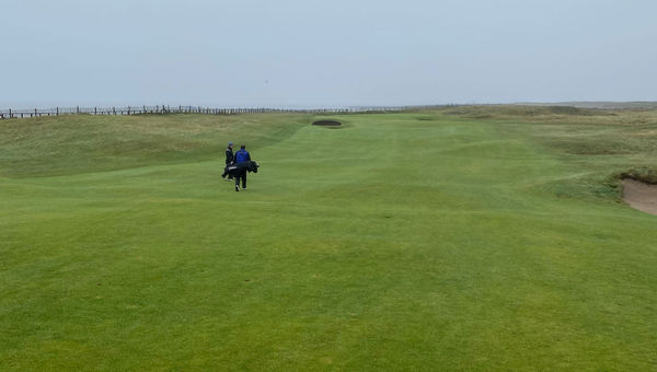 Walking toward the green on the second hole at Royal Porthcawl.