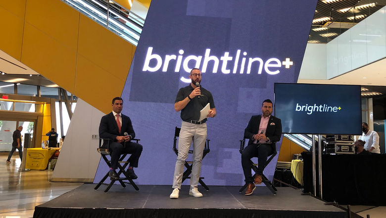 Miami Mayor Francis Suarez. left, appears with Brightline president Patrick Goddard, standing, and Carlos Cruz-Casas, the Miami-Dade County assistant director of Transportation and Public Works, at a press conference at Miami's Brightline station announcing the Brightline+ service.