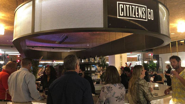 Guests sample some of the menu items at an open house for the new second floor food hall now open at the Brightline Miami station.