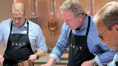 From left, Royal Caribbean Group CFO Jason Liberty, CEO Richard Fain and Silversea CEO Roberto Martinoli try their hand at preparing a warm honeyed fig salad in the S.A.L.T. Lab.