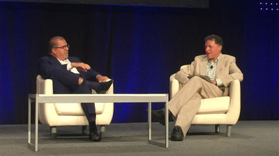 Norwegian Cruise Line Holdings CEO Frank Del Rio, left, speaks with Arnie Weissmann at CruiseWorld on Friday.