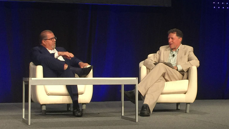 Norwegian Cruise Line Holdings CEO Frank Del Rio, left, speaks with Arnie Weissmann at CruiseWorld on Friday.
