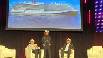 Carnival Cruise Line president Christine Duffy broke in on an interview of Carnival Corp. CEO Arnold Donald, right, by Travel Weekly editor in chief Arnie Weissmann to announce the name of the Carnival Jubilee.