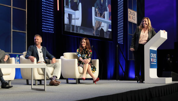 Adolfo Perez of Carnival Cruise Line and Michelle Sutter of Holland America Line on the Masterminds panel; Mary Pat Sullivan of Northstar Travel Group, standing, moderated. Adolfo Perez of Carnival Cruise Line and Michelle Sutter of Holland America Line on the Masterminds panel; Mary Pat Sullivan of Northstar Travel Group, standing, moderated.