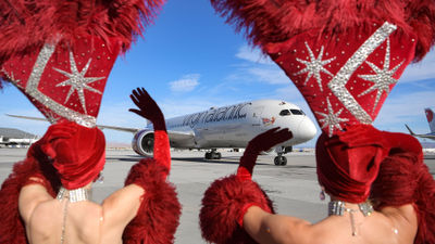 Showgirls welcome Virgin Atlantic Flight 155 from London as it arrives at McCarran Airport on Nov. 8.
