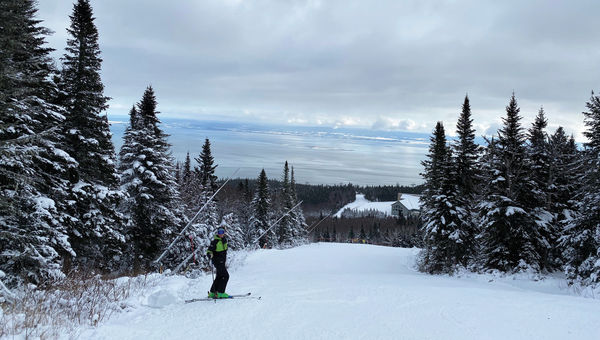 A skier is backed by the St. Lawrence River at Massif Charlevoix. The resort sits at the base of the ski area. A skier is backed by the St. Lawrence River at Massif Charlevoix. The resort sits at the base of the ski area.