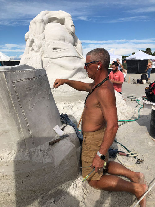 Matt Deibert at work on his sculpture Hand Me Down Genes, which won third place in the Tandem category at the 2021 Crystal Classic Sand Sculpting Festival on Siesta Key.