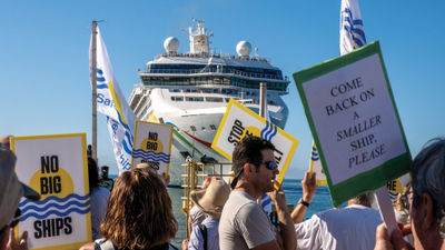 People protested the arrival of the 2,200-passenger Norwegian Dawn.