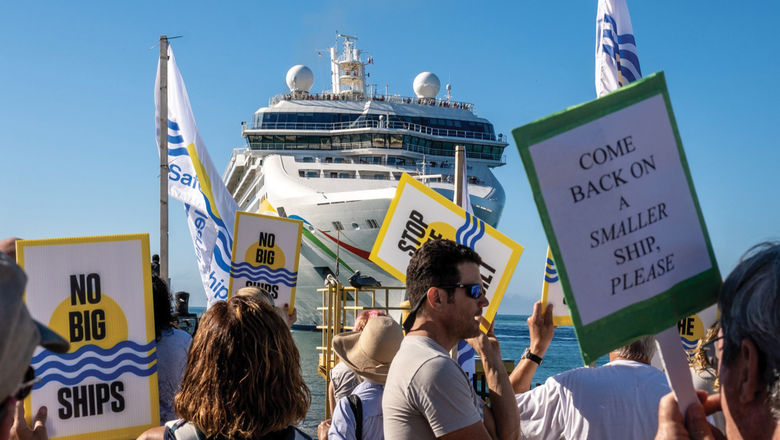 People protested the arrival of the 2,200-passenger Norwegian Dawn.