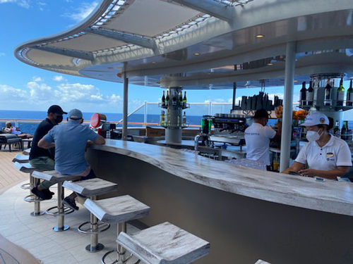 Guests at the bar on the MSC Seashore's lido deck. Guests at the bar on the MSC Seashore's lido deck.