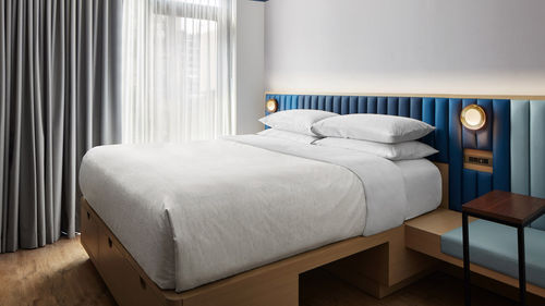 The 347 rooms at the Motto by Hilton New York City Chelsea come in a variety of sleeping arrangements, including a king bed that stows into the wall, bunk beds and four twin beds in a single room. The 347 rooms at the Motto by Hilton New York City Chelsea come in a variety of sleeping arrangements, including a king bed that stows into the wall, bunk beds and four twin beds in a single room.