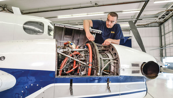A Pittsburgh Institute of Aeronautics student examines landing gear.