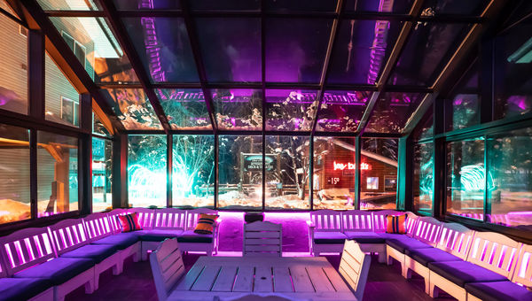 The Aurora Conservatory features three walls of glass, a glass ceiling, a fireplace, and various seating options. The Aurora Conservatory features three walls of glass, a glass ceiling, a fireplace, and various seating options.