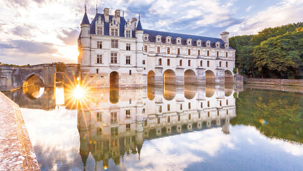 The water mirror effect on the Chateau de Chenonceau, which spans the river Cher. The water mirror effect on the Chateau de Chenonceau, which spans the river Cher.